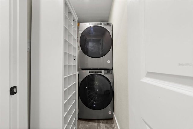 129 Rogers Pl, Port Orange, FL 32127 - laundry area featuring stacked washer / dryer and marble look tiles