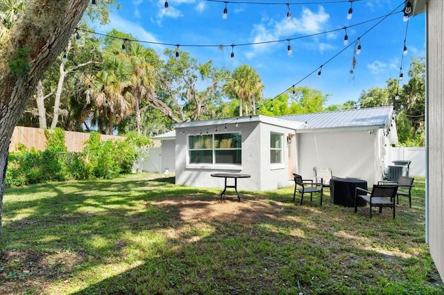 129 Rogers Pl, Port Orange, FL 32127 - back of property with stucco siding, a fenced backyard, and a metal roof