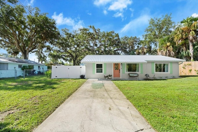 129 Rogers Pl, Port Orange, FL 32127 - ranch-style house with a gate, stucco siding, a metal roof, and driveway