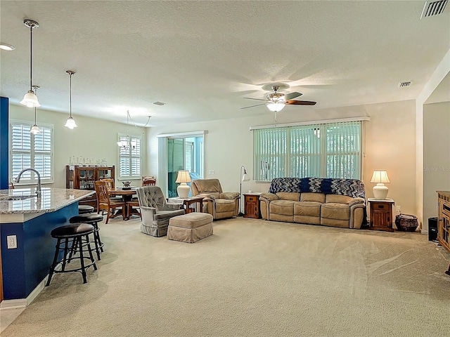 3361 Pegaso Ave, New Smyrna Beach, FL 32168 - living room featuring light colored carpet, a ceiling fan, and a textured ceiling