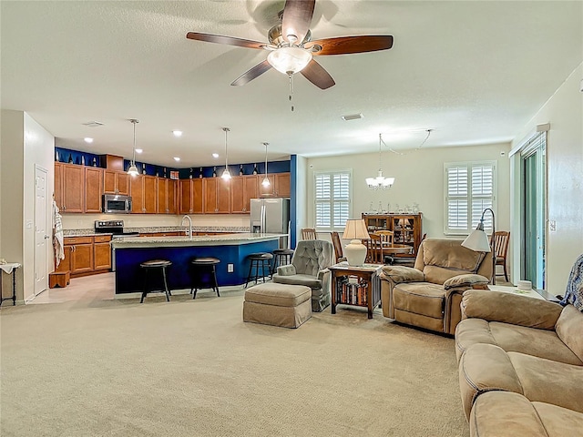 3361 Pegaso Ave, New Smyrna Beach, FL 32168 - living room featuring light colored carpet, a ceiling fan, and a chandelier