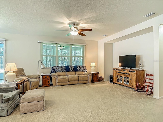 3361 Pegaso Ave, New Smyrna Beach, FL 32168 - living room featuring ceiling fan, carpet, and a textured ceiling
