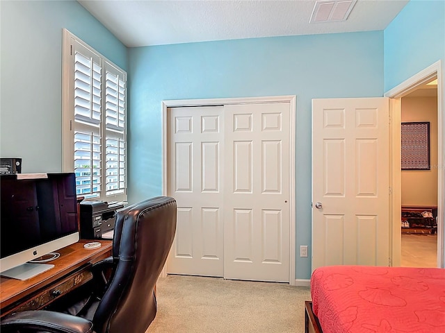 3361 Pegaso Ave, New Smyrna Beach, FL 32168 - bedroom featuring light colored carpet, a closet, and a desk
