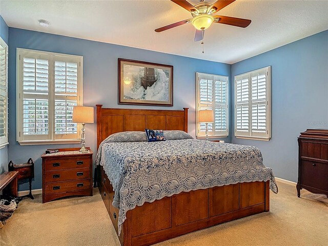 3361 Pegaso Ave, New Smyrna Beach, FL 32168 - bedroom with light colored carpet, multiple windows, and a ceiling fan