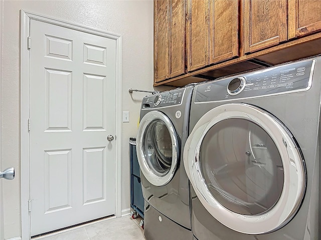3361 Pegaso Ave, New Smyrna Beach, FL 32168 - washroom with cabinet space, washer and dryer, and light tile patterned floors