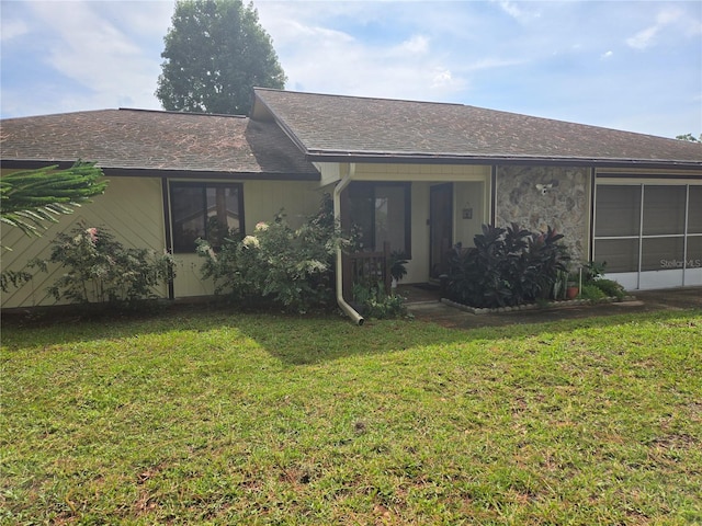 2941 Queen Palm Dr, Edgewater, FL 32141 - back of house featuring a yard, roof with shingles, and an attached garage