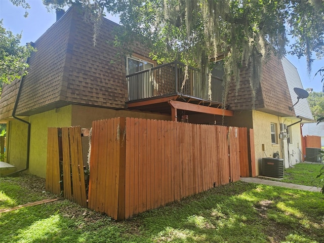 103 Springwood Sq, Port Orange, FL 32129 - view of home's exterior with mansard roof, roof with shingles, and stucco siding