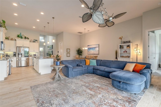 2931 Bella Flore Ter, New Smyrna Beach, FL 32168 - living area featuring a ceiling fan, light wood-style floors, and recessed lighting