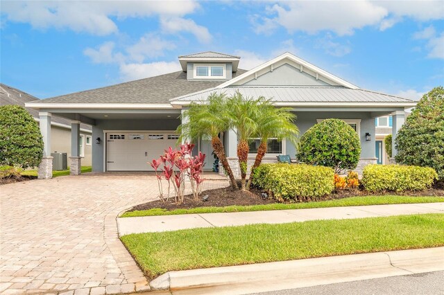 2931 Bella Flore Ter, New Smyrna Beach, FL 32168 - view of front of property featuring a garage, driveway, and stucco siding