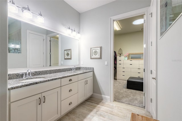 2931 Bella Flore Ter, New Smyrna Beach, FL 32168 - ensuite bathroom with double vanity and wood finished floors