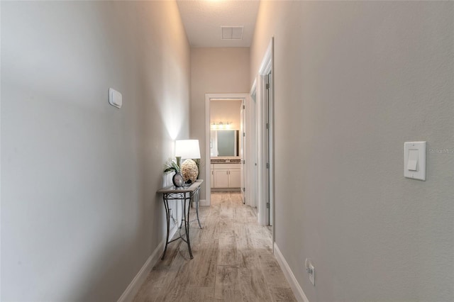 2931 Bella Flore Ter, New Smyrna Beach, FL 32168 - corridor with light wood finished floors and baseboards