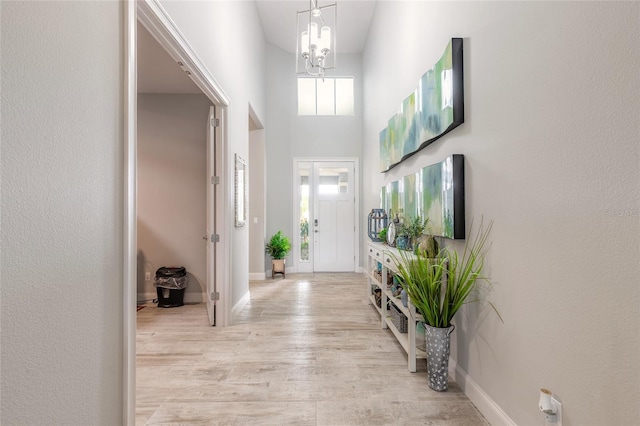 2931 Bella Flore Ter, New Smyrna Beach, FL 32168 - entrance foyer with a chandelier, light wood finished floors, and a high ceiling