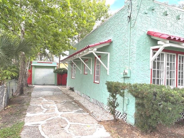 322 Taylor Ave, Daytona Beach, FL 32114 - view of side of home with driveway, an outbuilding, crawl space, and stucco siding