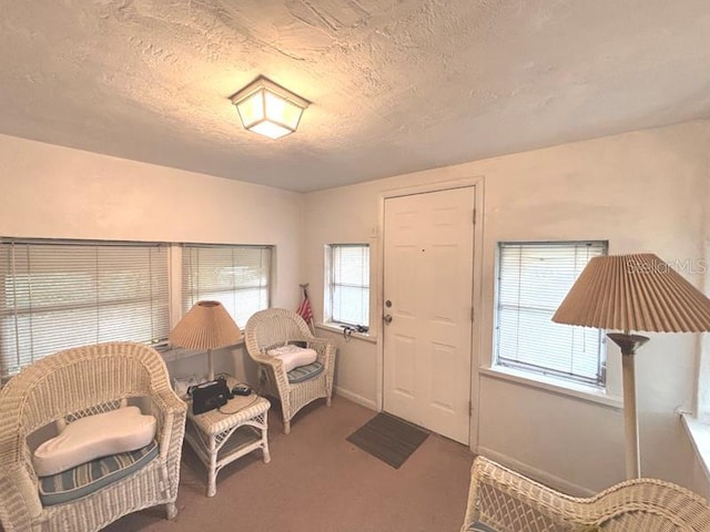 322 Taylor Ave, Daytona Beach, FL 32114 - carpeted entrance foyer featuring a textured ceiling and baseboards