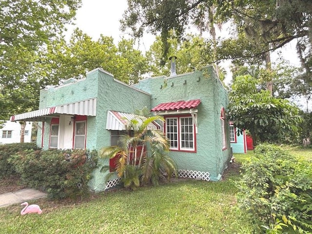 322 Taylor Ave, Daytona Beach, FL 32114 - view of front of property featuring a front yard and stucco siding