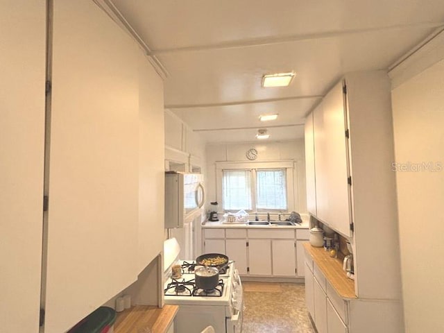 322 Taylor Ave, Daytona Beach, FL 32114 - kitchen featuring white appliances, light countertops, and white cabinets