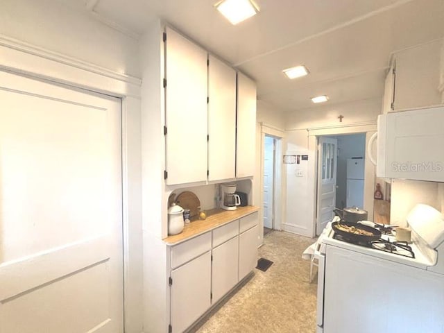 322 Taylor Ave, Daytona Beach, FL 32114 - kitchen with white appliances, light countertops, and white cabinets