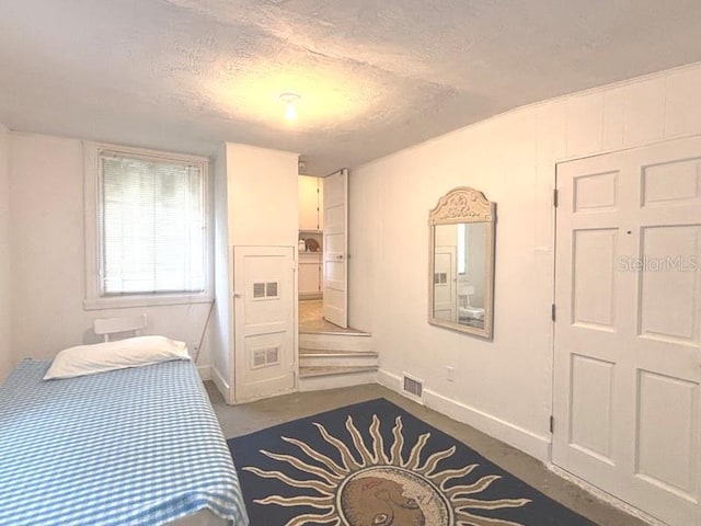 322 Taylor Ave, Daytona Beach, FL 32114 - bedroom featuring baseboards and a textured ceiling