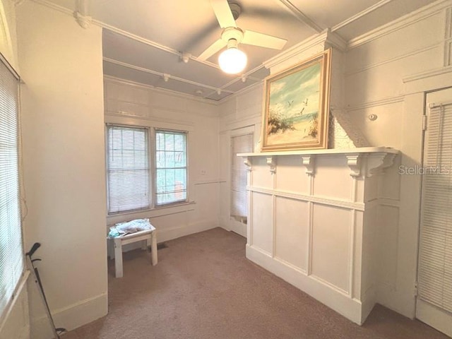 322 Taylor Ave, Daytona Beach, FL 32114 - interior space featuring crown molding, light carpet, a decorative wall, and a ceiling fan