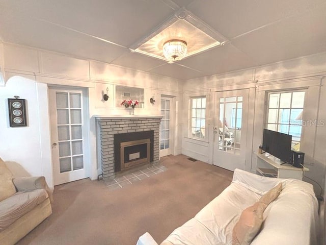 322 Taylor Ave, Daytona Beach, FL 32114 - living room with carpet floors, a brick fireplace, and plenty of natural light