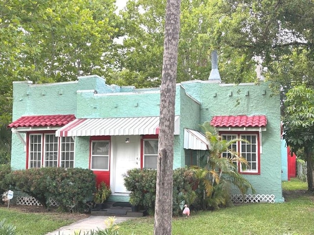 322 Taylor Ave, Daytona Beach, FL 32114 - mediterranean / spanish-style home featuring a front lawn and stucco siding