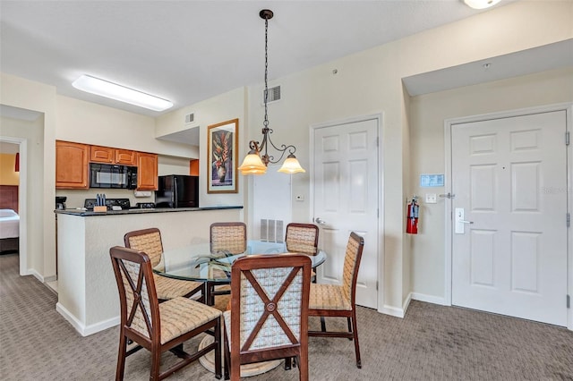 dining room featuring light colored carpet