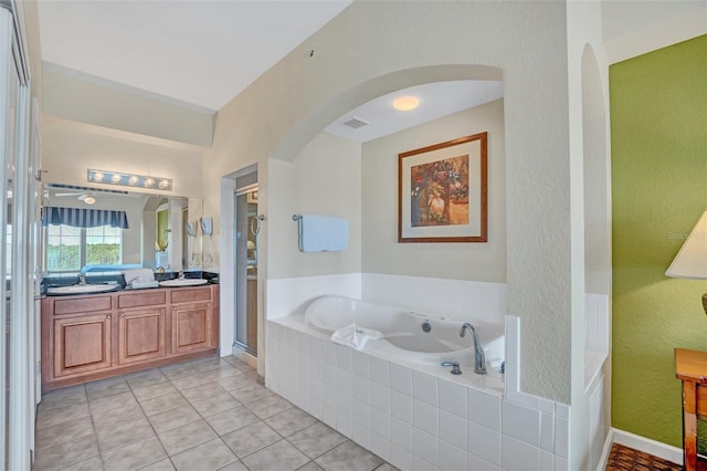 bathroom featuring tile patterned floors, vanity, and plus walk in shower