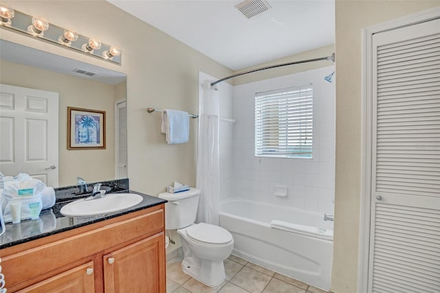 full bathroom with tile patterned flooring, vanity, toilet, and tiled shower / bath