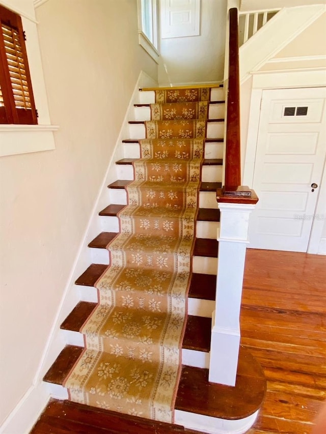 stairway featuring hardwood / wood-style floors