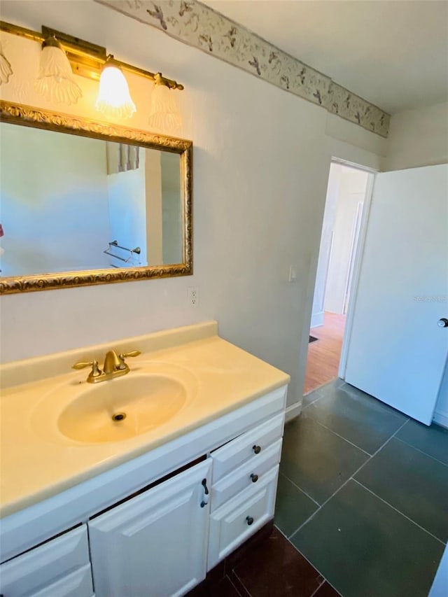 bathroom with tile floors and vanity