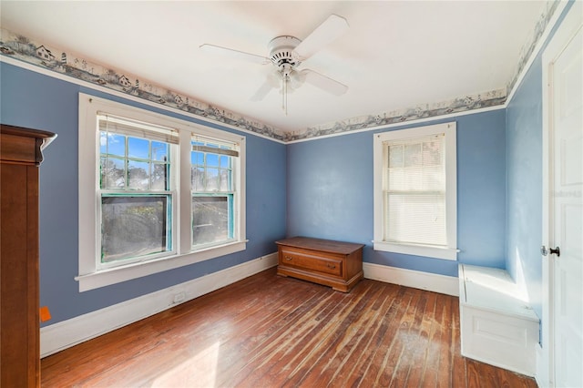 spare room with dark hardwood / wood-style flooring and ceiling fan