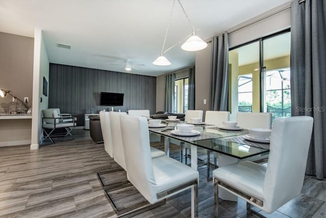 dining room with wood-type flooring and ceiling fan