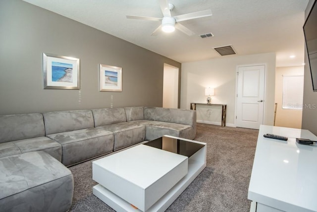 carpeted living room featuring ceiling fan