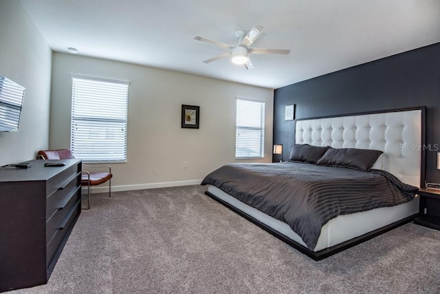 bedroom featuring ceiling fan and dark colored carpet