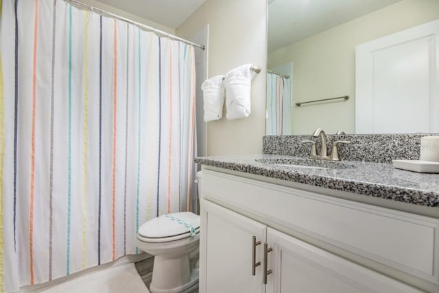 bathroom featuring oversized vanity and toilet