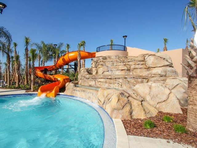 view of swimming pool featuring a water slide