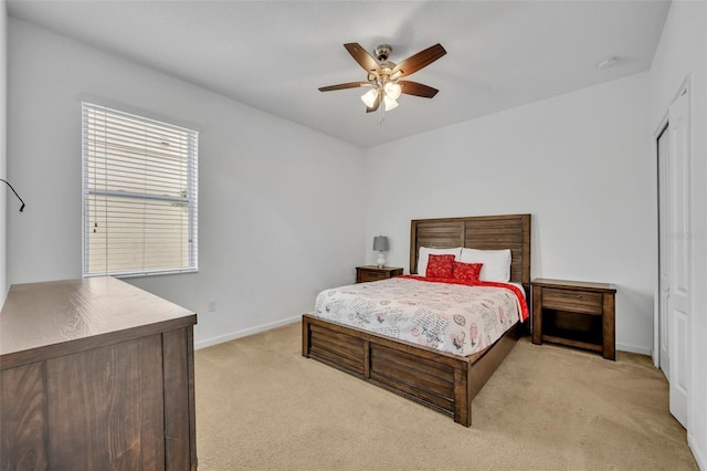 bedroom with light carpet and ceiling fan