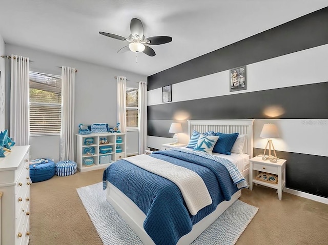 bedroom featuring ceiling fan, multiple windows, and carpet