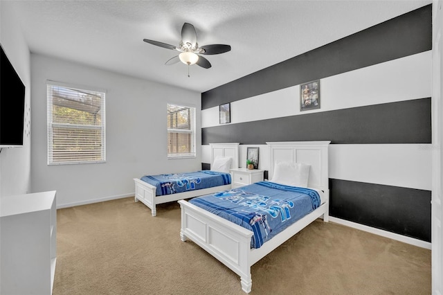 carpeted bedroom featuring a textured ceiling and ceiling fan