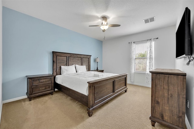 bedroom with ceiling fan and light colored carpet