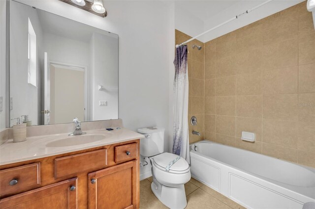 full bathroom featuring toilet, vanity, tile patterned flooring, and shower / bath combo