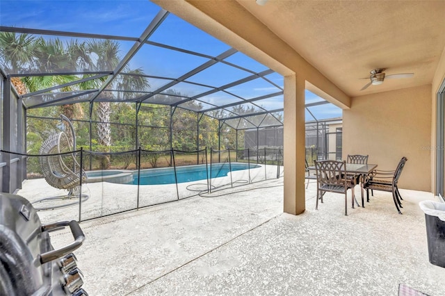 view of patio / terrace featuring ceiling fan and a lanai