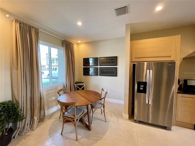 dining space with light tile flooring