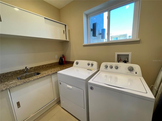 laundry room with washer hookup, light tile floors, washing machine and clothes dryer, and sink