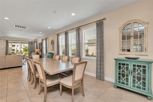 dining space featuring light tile flooring