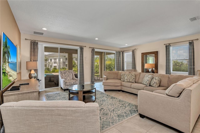 living room with a healthy amount of sunlight and light tile floors