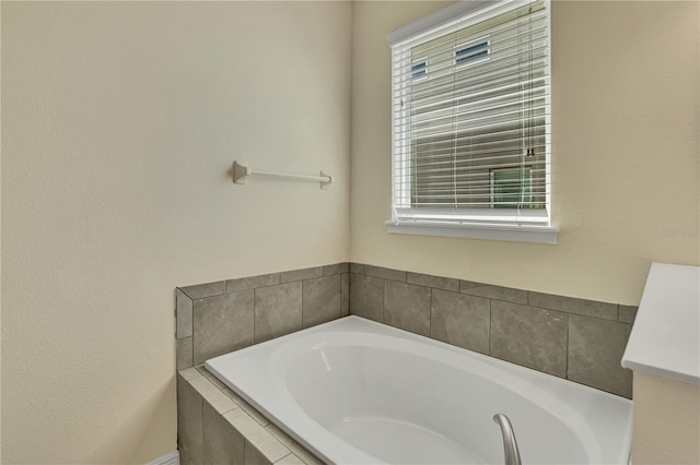 bathroom featuring tiled tub