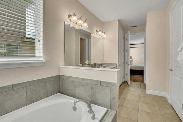 bathroom featuring tiled bath, tile floors, and large vanity