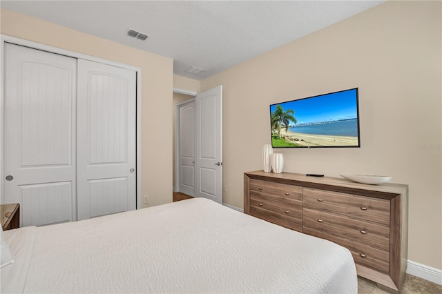 carpeted bedroom with a closet