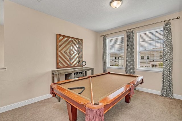 game room with a textured ceiling, light carpet, and pool table